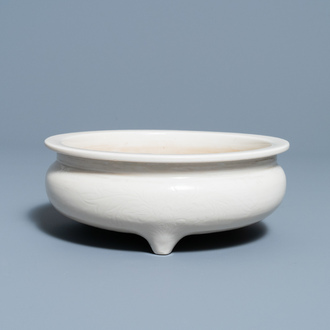 A Chinese Dehua blanc de Chine tripod censer with an incised design, Kangxi