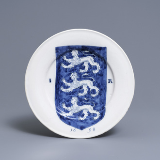 A Dutch Delft blue and white dish with the arms of James I, dated 1698