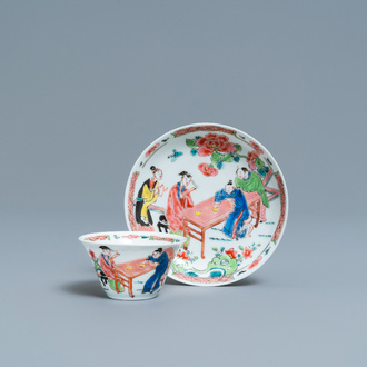 A Chinese famille rose 'tea scene' cup and saucer, Yongzheng/Qianlong