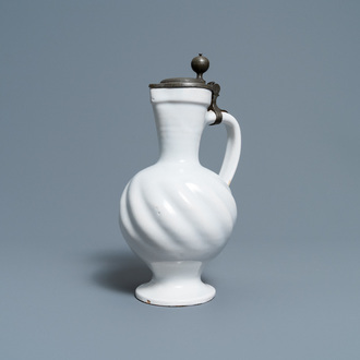 A gadrooned white Dutch Delftware jug with pewter cover, 17th C.