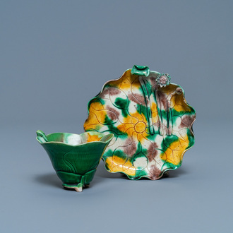 A Chinese 'egg and spinach'-glazed lotus cup and saucer with applied design, Kangxi