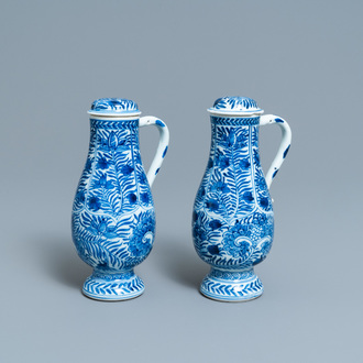 A pair of Chinese blue and white ewers and covers with floral design, Kangxi