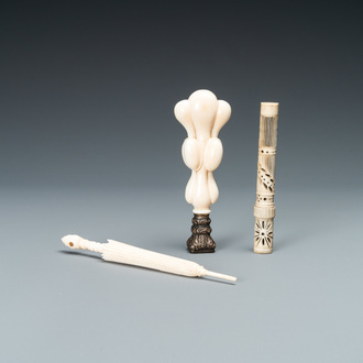 An ivory 'Stanhope' miniature umbrella with microscopical views on Paris, a seal stamp and a bone needle case, 19th C.