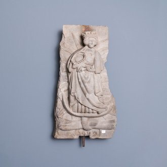 Un relief en grès gris sculpté figurant une Vierge à l'enfant, daté 1489