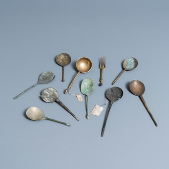 Nine brass spoons and a small fork, 15/16th C.
