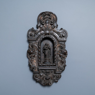 A patinated wooden niche with a Madonna with child flanked by cherub heads, 18th C.