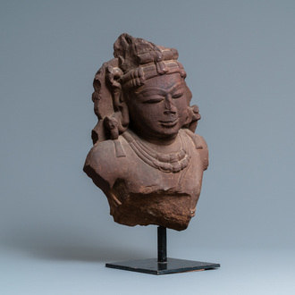 A fine red sandstone bust of a celestial nymph, Central India, 10/11th C.