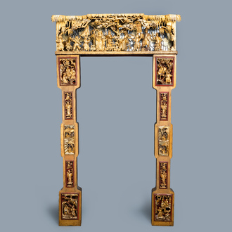 A Chinese gilded wood carving on matching pillars, 19th C.