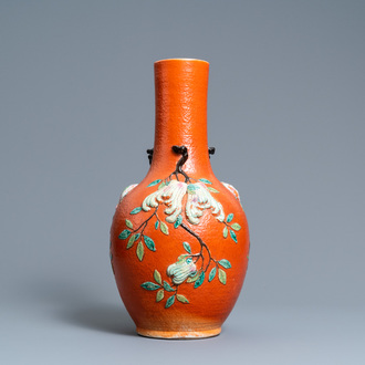 A Chinese famille rose 'sanduo' vase with applied design on a coral red ground, 19th C.