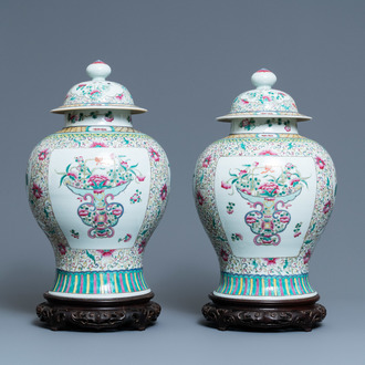 A pair of Chinese famille rose vases and covers, 19th C.