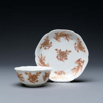 A Chinese iron-red and gilt 'phoenixes' cup and saucer, Kangxi