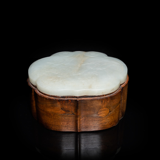 A Chinese wooden box with a white jade 'ruyi' plaque as cover, 18/19th C.