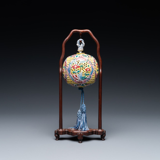 A Chinese reticulated famille rose fragrance ball, 19th C.