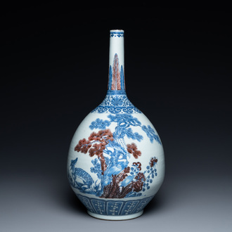 A Chinese blue, white and copper-red bottle vase with a deer and birds among blossoming branches, Daoguang