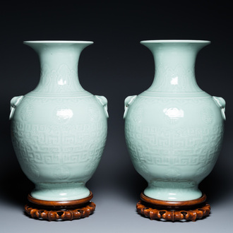 Une paire de vases en porcelaine de Chine en céladon monochrome sur socles en bois, marque de Qianlong, 18/19ème
