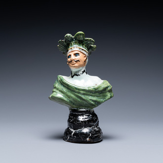 A polychrome French faience candlestick in the shape of a man, 18th C.