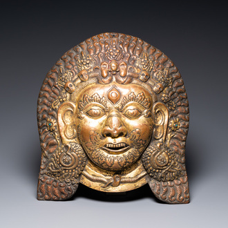 A large Tibetan gilt copper repoussé mask of Bhairava, Tibet or Nepal, 19th C.