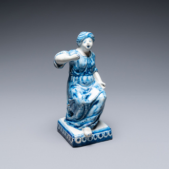 A Dutch Delft blue and white figure of a seated lady, 18th C.