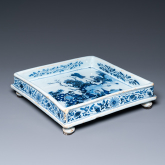 A Dutch Delft blue and white square footed tray on ball feet with chinoiserie design, late 17th C.