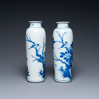 A pair of Chinese blue and white rouleau vases with birds among blossoming branches, Transitional period