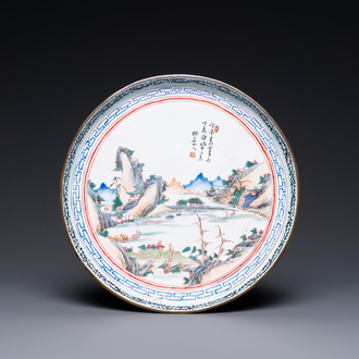 Une assiette en émaux de Canton à décor d'un paysage, Qianlong
