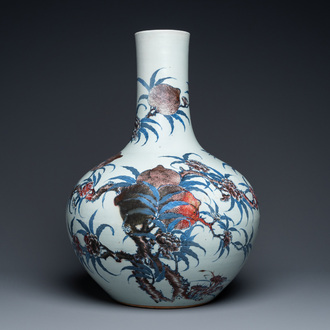 A Chinese blue, white and copper-red 'nine peaches' bottle vase, Guangxu mark and of the period