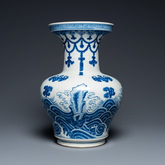 A Chinese blue and white vase with rocks in a wavy sea, Qianlong/Jiaqing