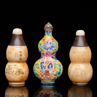 A Chinese Canton enamel snuff bottle and a pair of bone snuff bottles, 19th C.