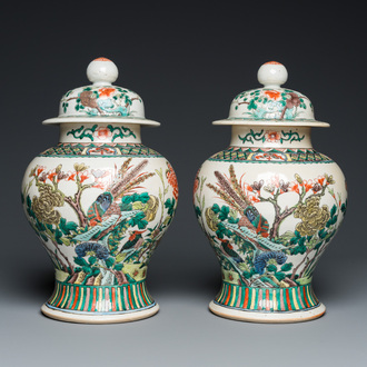 A pair of Chinese Nanking famille verte vases and covers, 19th C.