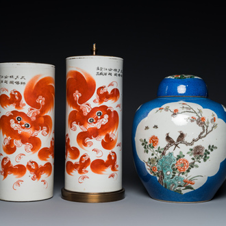 A pair of Chinese iron-red 'Buddhist lion' hat stands and a famille verte jar and cover, 19th C.