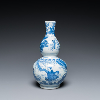 A Chinese blue and white double gourd vase with figures in a landscape, Transitional period