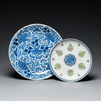 A Chinese blue and white 'peony scroll' dish and a famille verte dish, Kangxi