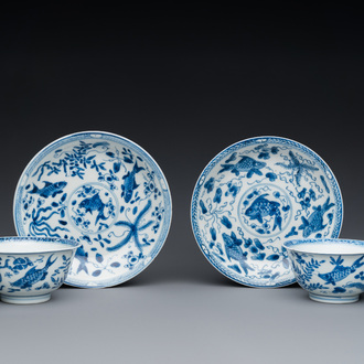 A pair of Chinese blue and white 'carps' cups and saucers, Kangxi