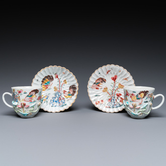 A pair of Chinese famille rose relief-decorated cups and saucers, Yongzheng