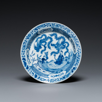 A Chinese blue and white 'two phoenixes and an immortal' plate, Kangxi/Yongzheng