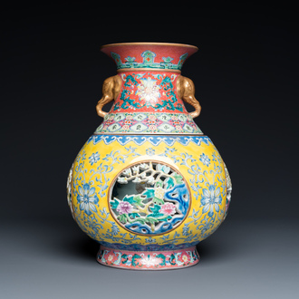 A Chinese reticulated and revolving famille rose vase consisting of two parts, Qianlong mark, 20th C.