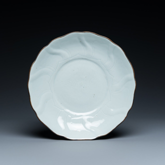 A Chinese lotus-molded white-glazed plate with incised lotus design, Xuande mark, Transitional period