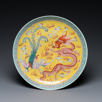 Plat en porcelaine de Chine famille rose à décor d'un dragon et d'un phénix sur fond jaune, marque de Qianlong, 19/20ème
