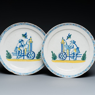 A pair of polychrome Dutch Delft plates depicting grinders, 18th C.
