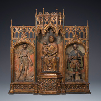 A large Spanish gilt and polychromed wooden triptych retable with Saint John the Baptist, the Virgin Mary and Saint Roch, 1st half 16th C.