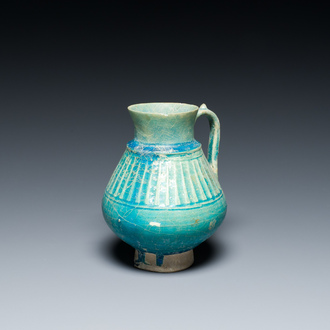 A turquoise-glazed jug, Kashan, Persia, 13th C.