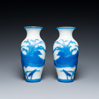 A pair of Chinese overlay Beijing glass vases with mandarin ducks in blue on white, 19/20th C.