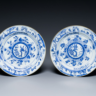 A pair of Chinese blue and white dishes with raised central medallions, Kangxi