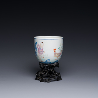 A Chinese famille rose cup with a boy and a rooster on wooden base, Qianlong mark, 20th C.