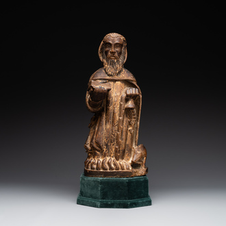 A large Burgundian stone sculpture of Saint Anthony the Great with attributes, France, 14th C.