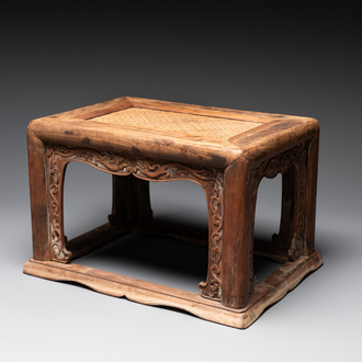 A Chinese rectangular huanghuali wooden stool with 'chilong' design, 17/18th C.