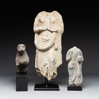 Two Gandhara grey schist torsos of Buddha and a tiger sculpture, 1st/3rd C.