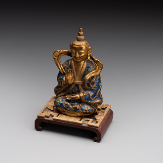 A Chinese gilt and champlevé enamelled bronze Bodhisattva on a carved stone stand, Qing