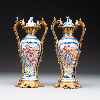 A pair of Chinese Canton famille rose 'mandarin subject' vases with gilt bronze mounts, Qianlong