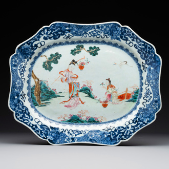 A Chinese famille rose 'He Xiangu' charger with a blue and white border, Qianlong